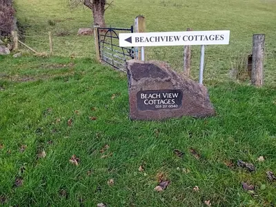 a sign for the beach view courses in a field at Beachview Cottage Co. Antrim in Cushendun