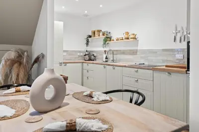 a kitchen with a table with a vase on it at Luxury 3 Bedroom Cottage in Centre of Killin in Killin