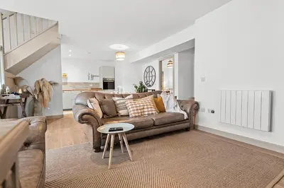 a living room with a couch and a table at Luxury 3 Bedroom Cottage in Centre of Killin in Killin