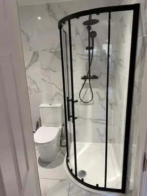 a white bathroom with a shower and a toilet at Dunfermline 2 Bed Flat Fully Furnished in Dunfermline