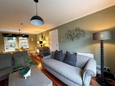 a living room with a couch and a table at Coorie Neuk in Cairnbaan