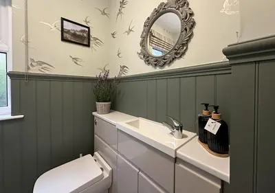 a bathroom with a toilet and a mirror at Coorie Neuk in Cairnbaan