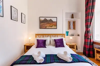 a bedroom with a bed with towels on it at Great Location! 2BD,2 Bath in Centre of Edinburgh in Edinburgh