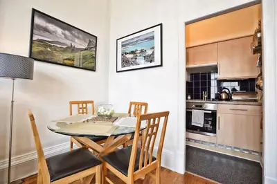a kitchen and dining room with a table and chairs at Great Location! 2BD,2 Bath in Centre of Edinburgh in Edinburgh