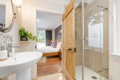 a bathroom with a shower and a sink and a toilet at Scenic Oaklodge with wood burner in Saint Fillans