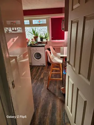 a small kitchen with a table and a stove at Double room available in Livingston