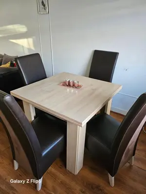 a wooden table with black chairs around it at Double room available in Livingston