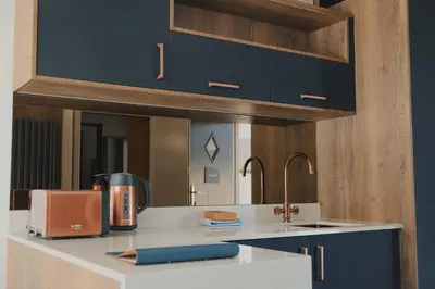 a kitchen with a counter with a sink and aounter at Jackton Distillery Steadings in Busby