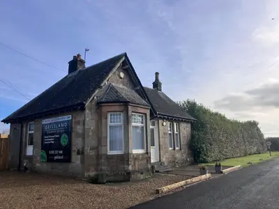 a small building on the side of a road at The Gatehouse, 2 bedroom detached cottage in Beith