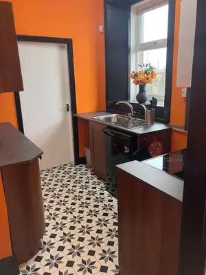 a kitchen with a black and white tile floor at The Gatehouse, 2 bedroom detached cottage in Beith