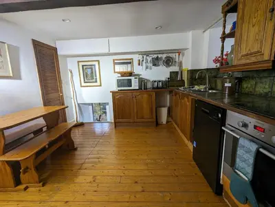 a kitchen with a wooden floor and a counter top at The Hidden Mill, Historic Beauty Spot and spa in Castle Douglas