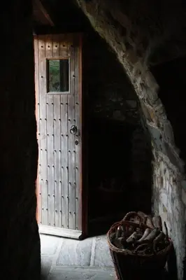 a door in a room with a basket next to it at The Hidden Mill, Historic Beauty Spot and spa in Castle Douglas