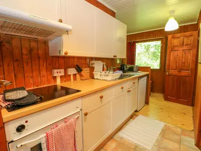 a kitchen with white cabinets and a counter top at Lodge 2 - 
