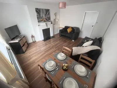 an overhead view of a living room with a table and a couch at Mitchell House in Bellshill