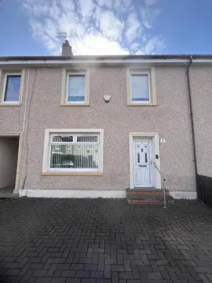 a brick house with a white door at Mitchell House in Bellshill