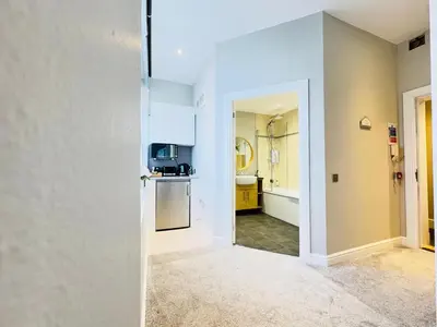 an empty room with a kitchen and a hallway at Top Floor Getaway with Cozy Canopy Bed in Edinburgh