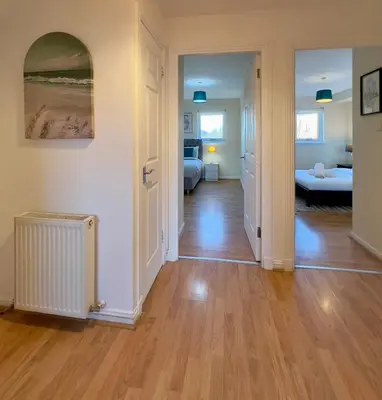 an open hallway with a living room and a bedroom at Sleek & Modern 2BR - Easy Access to City Centre in Glasgow