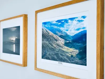 two framed photographs hanging on a wall at Top Floor Apartment with Castle Views in Edinburgh