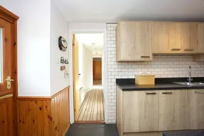 a kitchen with a sink and a counter top at Ivy Tree Cottage in Morenish