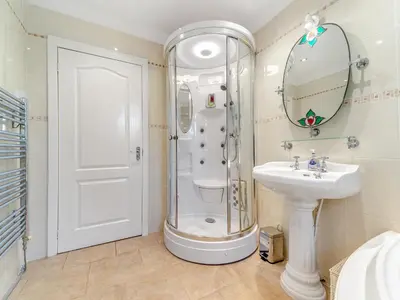 a bathroom with a shower and a sink and a mirror at Torland in Dalserf