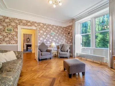 a living room with a couch and chairs and a table at Torland in Dalserf