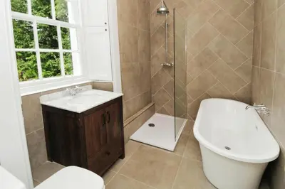 a bathroom with a toilet and a sink and a shower at Park Cottage - Spacious & Luxurious Room in B Listed Cottage in Moffat