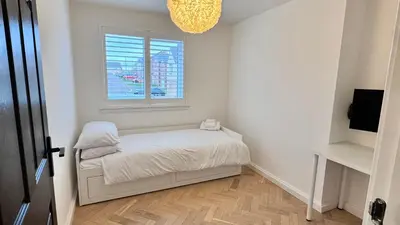 a small bedroom with a bed and a window at West Coast Home From Home in Stevenston