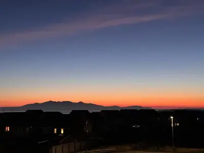 a view of a sunset with mountains in the background at West Coast Home From Home in Stevenston