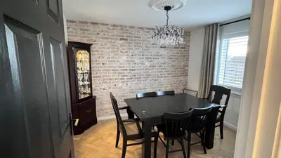 a dining room with a black table and chairs at West Coast Home From Home in Stevenston