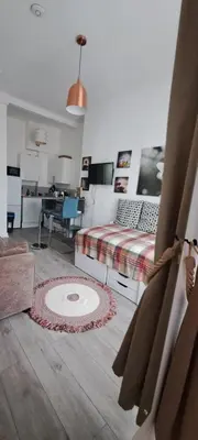 a bedroom with a bed and a living room at Cozy, modern flat in Govan in Glasgow