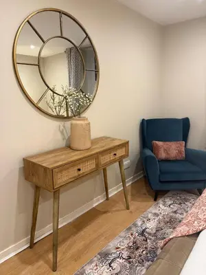 a dressing table with a mirror and a blue chair at Home away from home in Glasgow - Free Street Parking in Mansewood