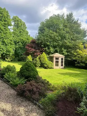 a small shed in the middle of a yard at Home away from home in Glasgow - Free Street Parking in Mansewood