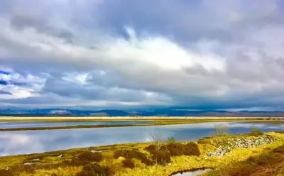 a large body of water under a cloudy sky at Cosy Karibu cottage with stunning canal views in Cairnbaan