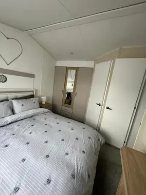 a bedroom with a large bed in a room at The Linwood at StrathavonRentals in Girvan