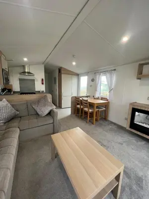 a living room with a couch and a table at The Linwood at StrathavonRentals in Girvan
