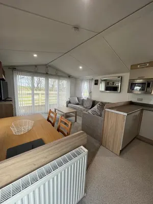 a living room with a kitchen and a dining room at The Linwood at StrathavonRentals in Girvan