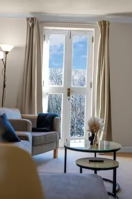 a living room with a couch and a table and a window at 1 Double Room in Shared apartment in Central Edinburgh with free parking in Edinburgh