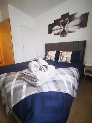 a bedroom with a bed with towels on it at Stevenson Apartment in Oban City in Oban
