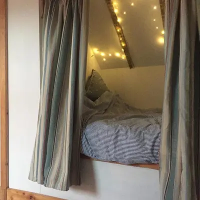 a bedroom with a bed in a room with a window at Holly Lodge, Gilchristland Organic Farm cottage in Closeburn