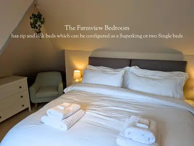 a bedroom with a bed with two towels on it at Mulberry Lodge Guest Suite - luxurious accommodation on West Highland Way in Drymen