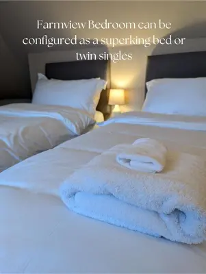 a pile of towels sitting on top of a bed at Mulberry Lodge Guest Suite - luxurious accommodation on West Highland Way in Drymen