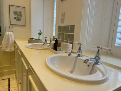 two sinks in a bathroom with two faucets at Mulberry Lodge Guest Suite - luxurious accommodation on West Highland Way in Drymen