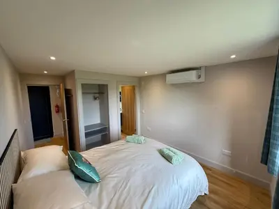 a bedroom with a bed with two pillows on it at Loganlea Lodge in Loanhead