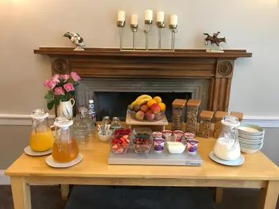 a table with a tray of fruit and juice at West Plean House in Stirling
