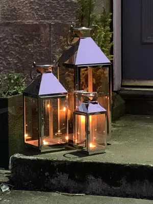 two glass lanterns with lights on a sidewalk at Creity Hall Guest House in Doune