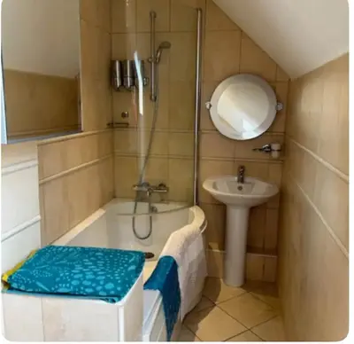 a bathroom with a bath tub and a sink at Sanda View, Isle of Arran in Sliddery