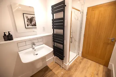 a bathroom with a sink and a shower at Bracken Lodge in Comrie