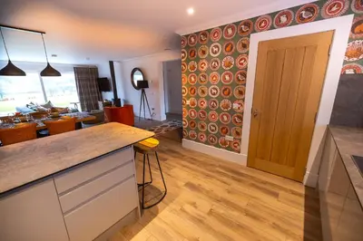 a kitchen with a counter and a dining room at Bracken Lodge in Comrie