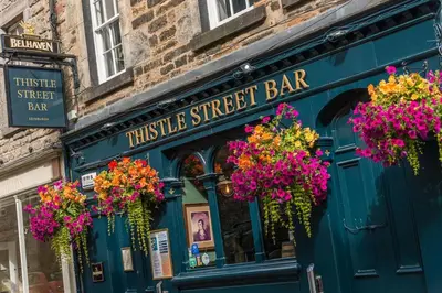 a pub with flowers on the front of it at The Cobbled Rider in Edinburgh