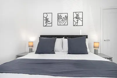 a bedroom with a bed with three pictures on the wall at Coaledge Coorie - A wee find in Fife in Fordell